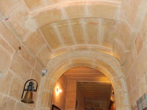 an archway in a building with a bell at The 3Cities Auberge in Cospicua