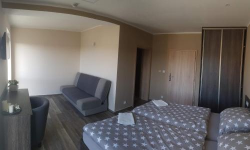 a hotel room with a bed and a chair at Holiday Centrum in Žatec