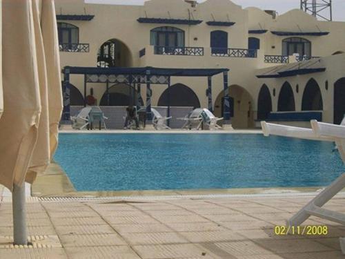 a swimming pool in front of a building at New Panorama Resort in Fayoum Center