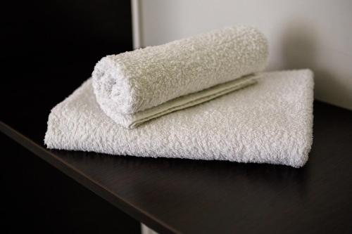 two towels are stacked on top of a table at Complex Adria Montenegro in Herceg-Novi