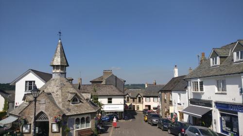 a city street with houses and a clock tower at Ring O Bells in Chagford