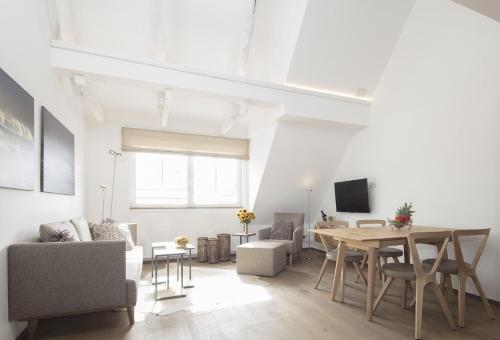 a living room with a table and a dining room at MeerBlickD21 Residenzen in Norderney
