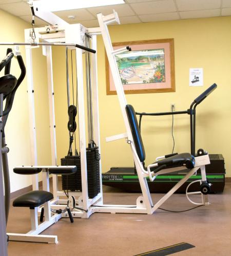 a room with a gym with two exercise equipment at Monumental Hotel Orlando in Orlando