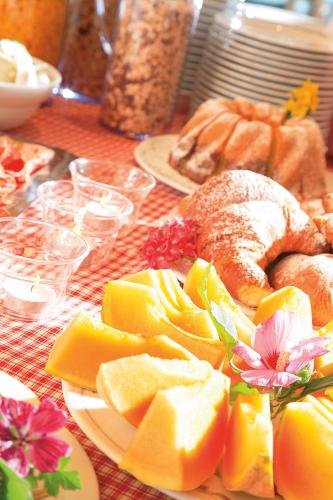 a table with plates of food on a table at Pension zum Burggräfler in Schenna