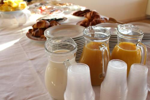 a table topped with glasses of milk and other drinks at Masseria Chinunno in Altamura