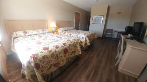 A bed or beds in a room at Vulcan Country Inn