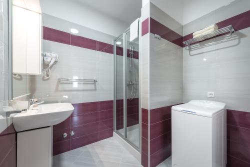 a bathroom with a toilet and a sink and a shower at Apartments Rilovic, City and Sea view apartments in Cavtat