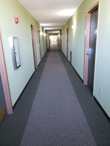 an empty hallway in an office building with a long corridor at Harbor Lights Lodge in Kewaunee