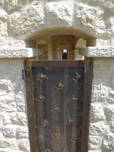 a door in a stone wall with bees on it at Les 4 éléments in Tourrettes-sur-Loup