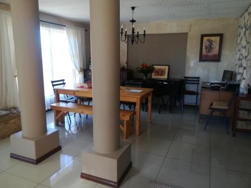 a kitchen and dining room with a table and columns at Tirzah's B&B and Self Catering in Bredasdorp