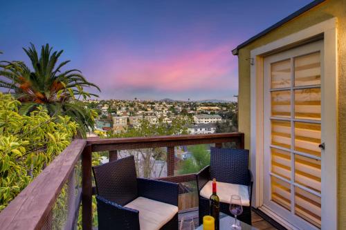 a balcony with two chairs and a bottle of wine at Casa California - Backyard, BBQ, Firepit & Near Beaches in San Diego