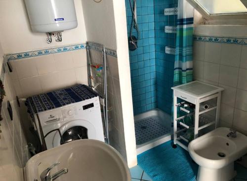 a bathroom with a sink and a washing machine at Casa delle Galee in Scilla