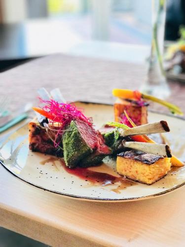 a plate of food sitting on a table at M13 Hotel in Riol