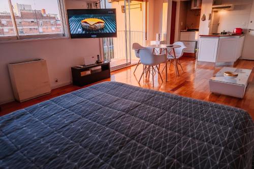 a bedroom with a large bed and a table with chairs at Deptis in Olivos