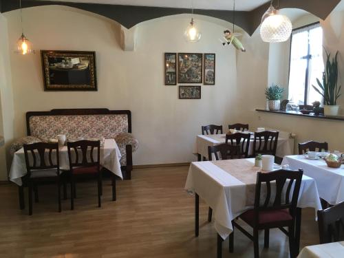 a dining room with white tables and chairs at Hotel Alt Annaberg in Annaberg-Buchholz