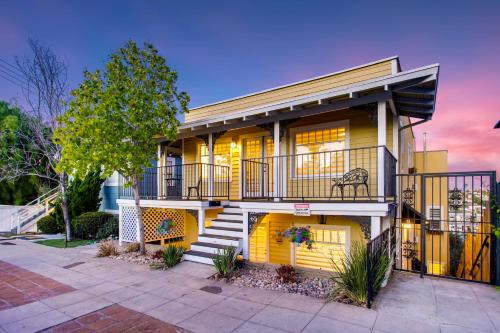 a house with a balcony and stairs in front of it at CasaViva Pacifica - 2BR Sleeps 10 with Firepit, BBQ & Shared Yard - Walk to Hillcrest Fun, Near Zoo, Balboa Park & Beaches in San Diego