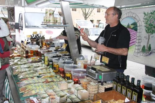 a man standing next to a table with bottles of wine at La Bastide de Fontaille in Saint-Félicien