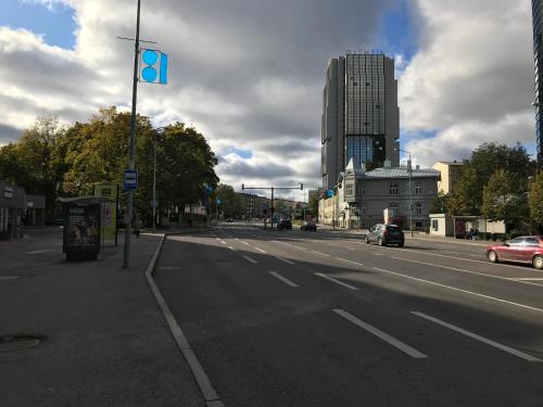 an empty city street with cars on the road at Liivalaia 40 cozy kitchen studio in Tallinn