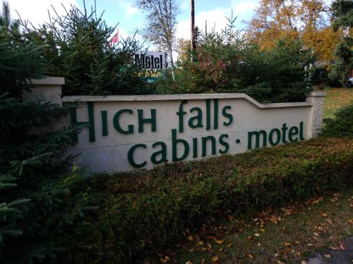 a sign that reads high falls calints media at High Falls Motel & Cabins in Wawa
