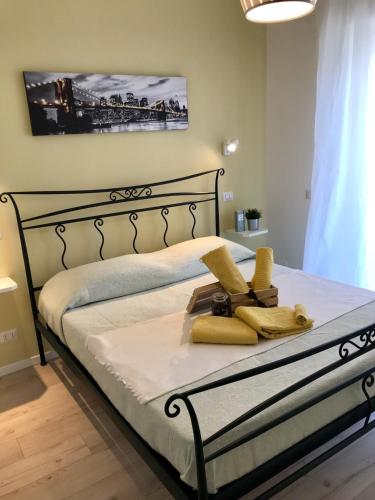 a bedroom with a bed with yellow towels on it at AzzurRomare Flat apartment in Lido di Ostia