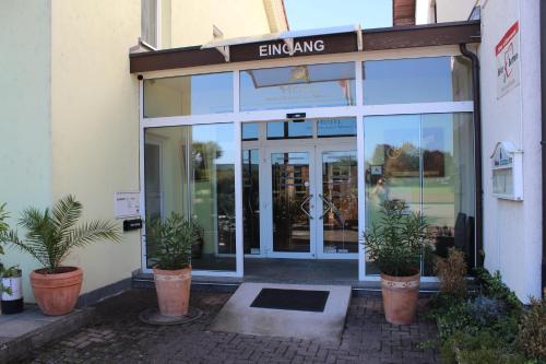an entrance to a store with plants in front of it at Hotel zum Goldenen Wagen in Maulburg