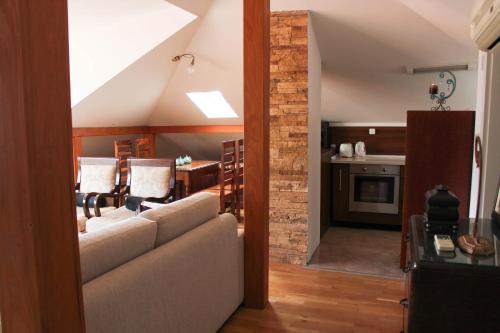 a living room with a couch and a kitchen at Jovevi Apartments in Ohrid