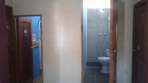 a bathroom with a toilet and a shower and a sink at My Little House Surf&backpacker Hostel in Montañita