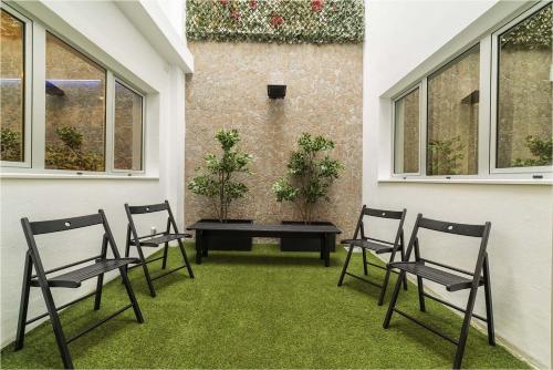 a group of chairs sitting on a patio with a table at Hotel Ciudad del Mar in Las Palmas de Gran Canaria