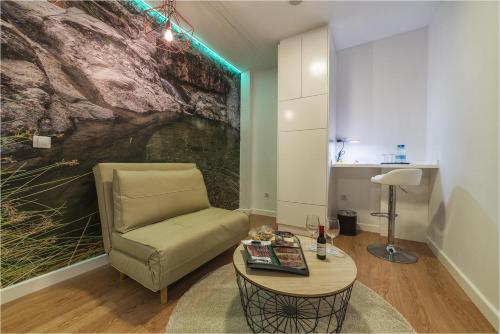 a living room with a chair and a table at Hotel Ciudad del Mar in Las Palmas de Gran Canaria