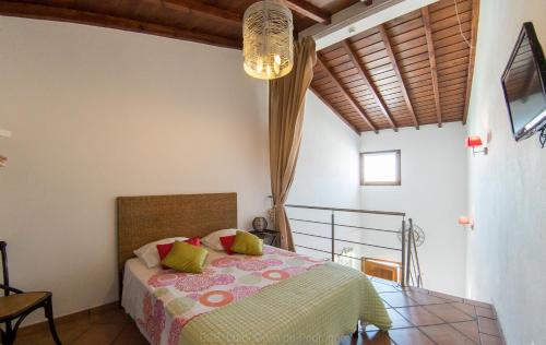 a bedroom with a bed and a chandelier at Casa de Pedrógão in Pedrógão