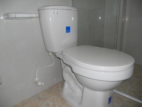 a bathroom with a white toilet in a room at Hotel Manzanares Baranoa in Baranoa