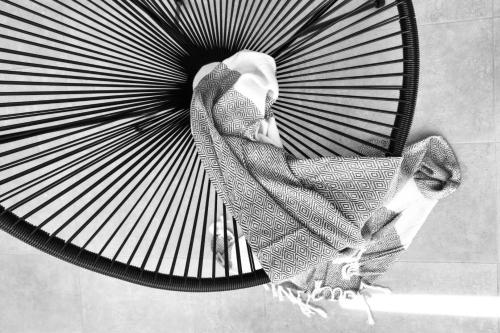 a woman sitting on top of a fan at Angelos Boutique Suites in Patitiri