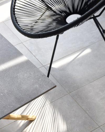 a black bench sitting on a tile floor at Angelos Boutique Suites in Patitiri
