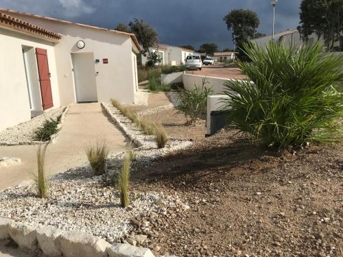 a driveway with plants in front of a building at Villa Louise in Bonifacio