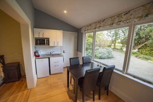 a kitchen and dining room with a table and chairs at Waipara River Estate in Waipara
