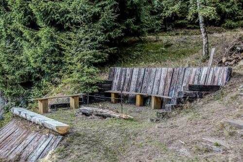 two wooden benches sitting on top of a hill at Chata Bajama in Bedřichov