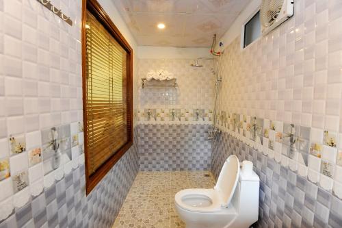 ein Badezimmer mit Toilette und Dusche in der Unterkunft Tam Coc Cosiana Hotel in Ninh Bình