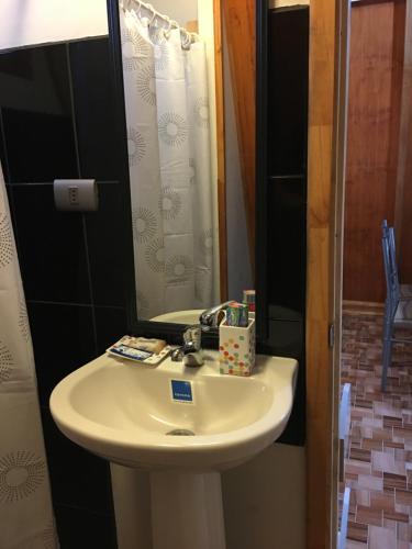 a bathroom with a sink and a shower with a mirror at Pyramidal Park Valdivia in Valdivia