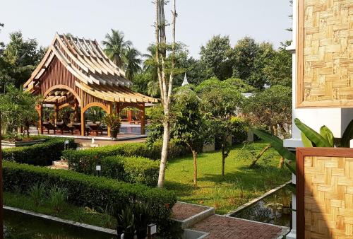 a building with a pavilion in a park at Le Palais Juliana in Luang Prabang