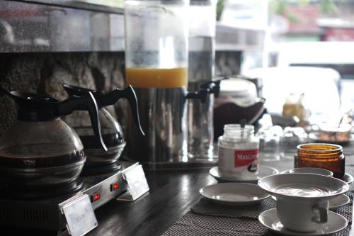 a counter top with a coffee maker and a drink at Suris Boutique Hotel in Kuta