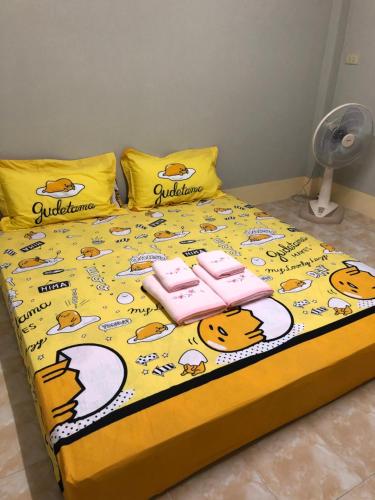 a bed with a hello kitty comforter on it at Pani House Hatyai 1 in Hat Yai