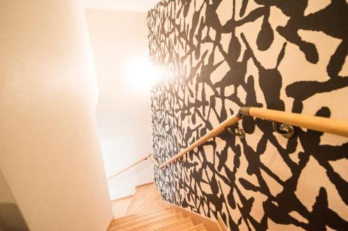 a room with a wall with a pattern on it at KYOSTAY Iroha Komichi in Kyoto