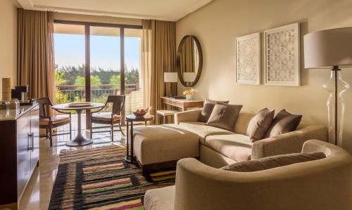 a living room with a couch and a table at Four Seasons Hotel Tunis in Gammarth