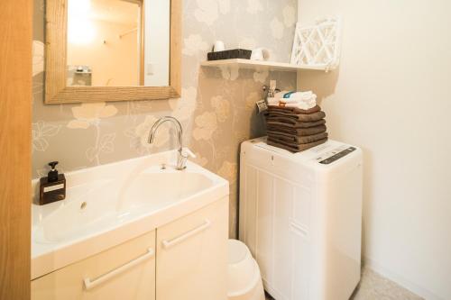 a bathroom with a sink and a toilet and a mirror at KYOSTAY Iroha Komichi in Kyoto