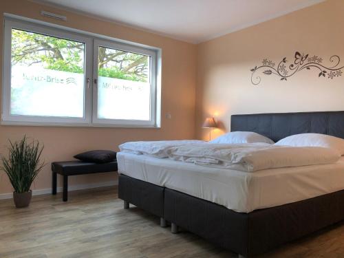 Un dormitorio con una cama grande y una ventana en MÜRITZ-BRISE en Waren