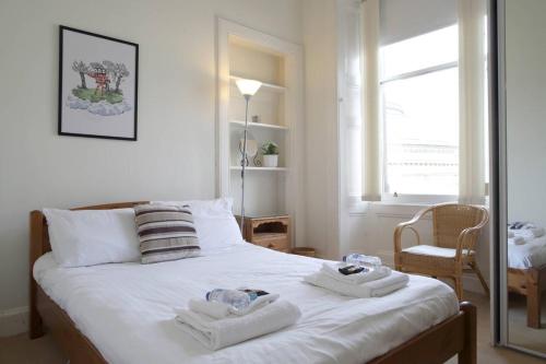 a bedroom with a bed with two towels on it at Grindlay Street Residence, 2 Bedroom, 2 Bathroom apartment close to Castle in Edinburgh