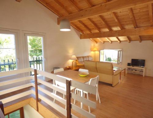 a living room with a table and a couch at Ihi-Toki in Saint-Pée-sur-Nivelle