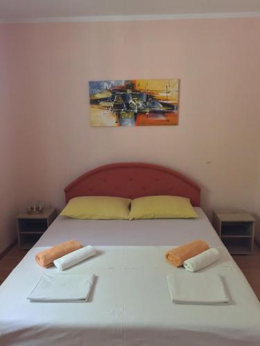 a bedroom with a bed with two towels on it at Holiday Home Aksentijevic in Sutomore