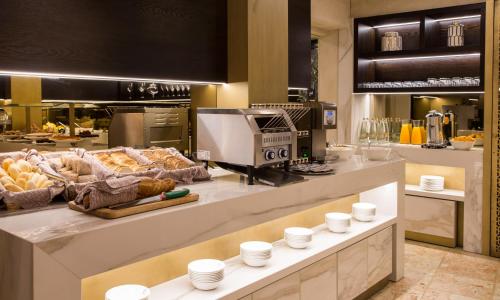 a kitchen with a counter with food on it at BW Premier Collection CHC Continental in Venice