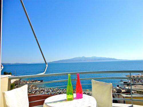 two colorful bottles sitting on top of a table on a balcony at Epirus Hotel in Sarandë